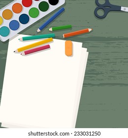 Art supplies on wooden desk (aquarel colors, pencils, papers & scissors)