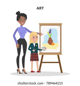 Art teacher with student learning to draw with paint.