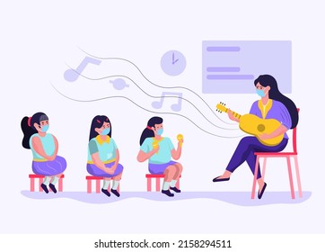 Art teacher teaching students to sing in the classroom, play guitar, good for children's education. And it's teaching in the situation of corvids. Everyone wears a mask. Keep social distance.