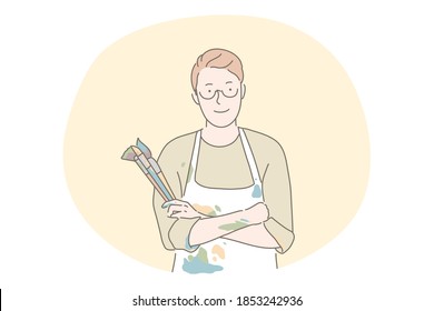 Artist, painter, artwork, drawing concept. Young man artist cartoon character standing in coloured apron and holding heap of painting brushes for making artwork or during workshop in art school 