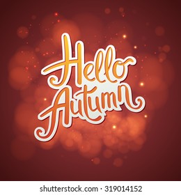 Artistic red Hello Autumn card design with scrolling script - Hello Autumn - over an abstract glowing red background with soft blurred bokeh and twinkling sparkles, vector ilustration