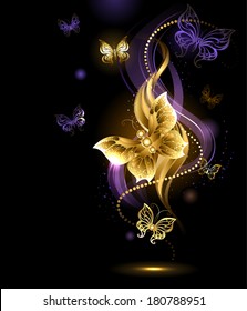 Artistically painted, gold jewelry butterfly on abstract dark background.