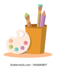 Artist's set with a palette of brushes and a pencil in a cup.