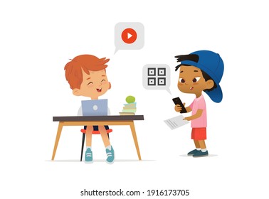 Asian American Boy scanning a code on their phone from a booklet and greeting classmate sitting at table and watching video