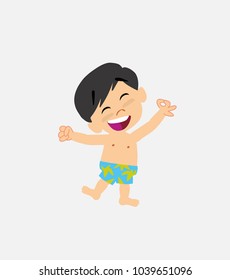 Asian boy in swimsuit exulting in happiness