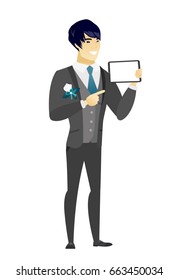 Asian bridegroom holding a tablet computer. Full length of bridegroom pointing at a tablet computer. Bridegroom with a tablet computer. Vector flat design illustration isolated on white background.