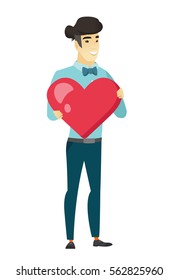 Asian business man showing a big red heart. Full length of young business man with heart shape. Happy business man holding a red heart. Vector flat design illustration isolated on white background.