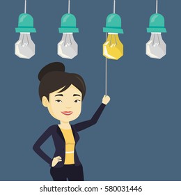 Asian business woman switching on hanging idea light bulb. Young cheerful business woman pulling a light switch. Business idea concept. Vector flat design illustration isolated on white background.