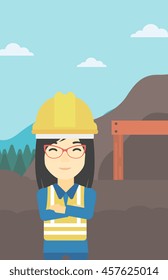An asian confident coal miner. Female miner standing in front of a big mining equipment on the background of coal mine. Vector flat design illustration. Vertical layout.
