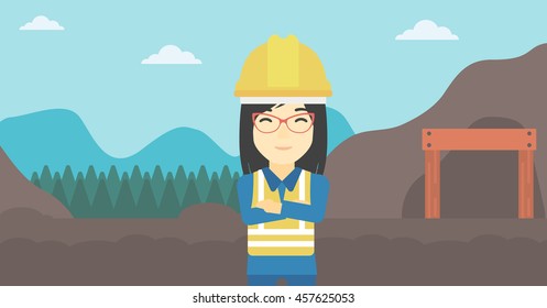 An asian confident coal miner. Female miner standing in front of a big mining equipment on the background of coal mine. Vector flat design illustration. Horizontal layout.