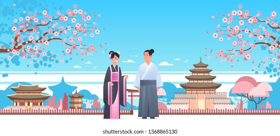 asian couple wearing traditional clothes man woman in ancient costume standing together chinese or japanese characters over pagoda buildings landscape background full length horizontal