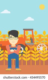 An asian farmer standing on the background of combine harvesting wheat. Young farmer working on a wheat field. Vector flat design illustration. Vertical layout.