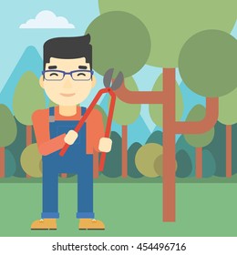 An asian farmer working with a pruner in the garden. Young man pruning branch. Gardener trimming branches in garden. Vector flat design illustration. Square layout.