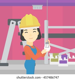 An asian female electrician twisting a light bulb. An electrician installing light in an apartment. Electrician changing light bulb. Vector flat design illustration. Square layout.