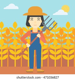 An asian female farmer holding a pitchfork. Smiling Farmer standing on the background of wheat field. Vector flat design illustration. Square layout.
