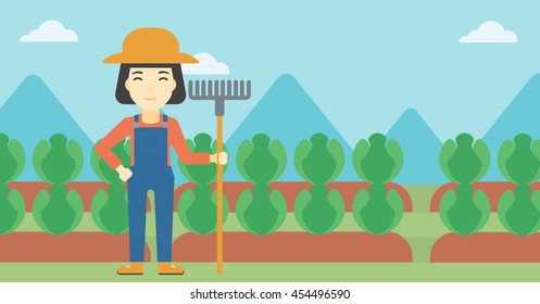 An asian female farmer holding a rake. Friendly farmer standing on the background of cabbage field. Vector flat design illustration. Horizontal layout.