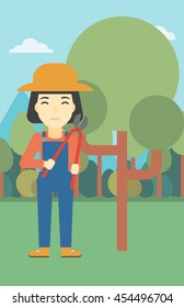 An asian female farmer working with a pruner in the garden. Young woman pruning branch. Gardener trimming branches in garden. Vector flat design illustration. Vertical layout.
