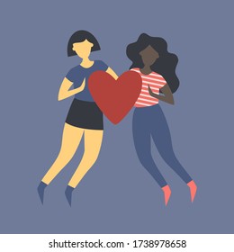 Asian girl and dark-skinned girl together hold the heart. Love between two girls. Unisex love. Love in the LGBT community.