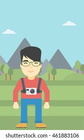An asian man with a digital camera on his chest. Tourist with a digital camera standing on the background of mountains. Vector flat design illustration. Vertical layout.