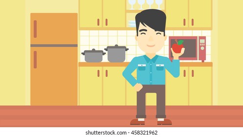 Ein asiatischer Mann, der einen Apfel in der Küche hält. Junge Mann, der in der Küche einen Apfel isst. Mann mit einem Apfel zu Hause. Vektorflache Design-Illustration. Horizontales Layout.