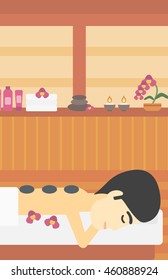 An asian man relaxing while getting stone therapy massage in the spa center. Man having back massage in spa salon. Vector flat design illustration. Vertical layout.