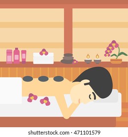 An asian man relaxing while getting stone therapy massage in the spa center. Man having back massage in spa salon. Vector flat design illustration. Square layout.
