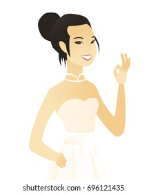 Asian smiling fiancee in white dress showing an ok sign. Young happy fiancee making an ok sign. Successful fiancee gesturing ok sign. Vector flat design illustration isolated on white background.