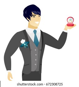 Asian smiling groom holding a red gift box with a diamond ring. Young groom holding wedding ring in a box. Vector flat design illustration isolated on white background.