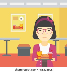 An asian woman holding tray full of junk food on a cafe background. Smiling woman in fast food restaurant. Woman having lunch in fast food restaurant. Vector flat design illustration. Square layout.