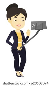 Asian woman making selfie with a selfie-stick. Smiling woman taking photo with cellphone. Young woman taking selfie and waving her hand. Vector flat design illustration isolated on white background.