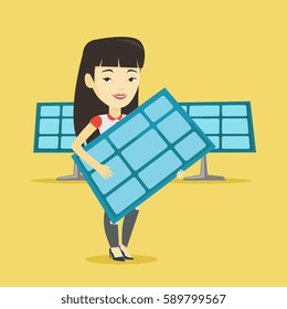 Asian worker of solar power plant holding solar panel in hands. Young woman with panel in hands standing on the background of solar power plant. Vector flat design illustration. Square layout.