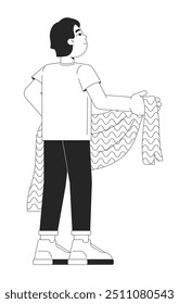 Asian young boy holding blanket black and white 2D line character. Standing back view schoolboy japanese little isolated vector outline person. Backstage kid. Monochromatic spot illustration