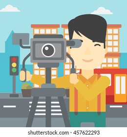 An asian young cameraman looking through movie camera on a tripod. Young man with professional video camera in the city. Vector flat design illustration. Square layout.