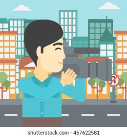 An asian young cameraman looking through movie camera. Man with professional video camera in the city. Cameraman shooting outdoor. Vector flat design illustration. Square layout.