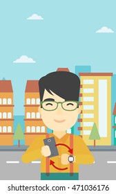An asian young man holding smartphone and looking at his smart watch. Concept of synchronization between smartwatch and smartphone. Vector flat design illustration. Vertical layout.