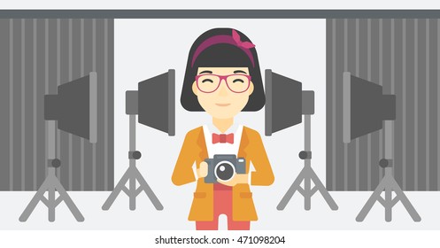 An asian young photographer holding a camera in photo studio. Photographer using camera in the studio. Woman taking photo with digital camera. Vector flat design illustration. Horizontal layout.
