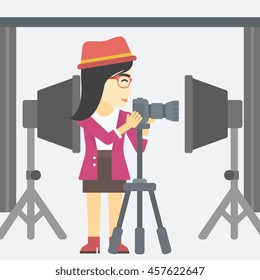 An asian young photographer working with camera on a tripod in photo studio. Woman taking photo with professional digital camera in the studio. Vector flat design illustration. Square layout.