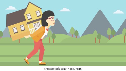 An asian young woman carrying a big house on her back on the background of mountains. Vector flat design illustration. Horizontal layout.