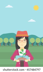 An asian young woman holding in hands plastic bottle with plant growing inside. Man holding plastic bottle used as plant pot. Recycling concept. Vector flat design illustration. Vertical layout.