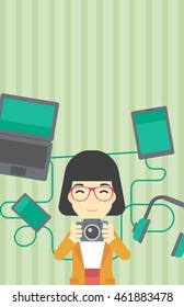 An asian young woman taking photo with digital camera. Woman surrounded with her electronic gadgets. Woman using many electronic gadgets. Vector flat design illustration. Vertical layout.