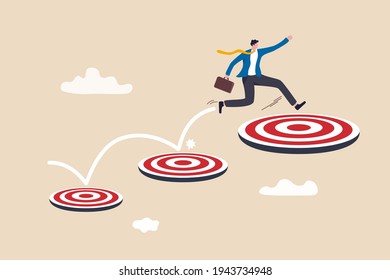 Aspiration and motivation to achieve bigger business target, advancement in career or business growth concept, smart businessman jumping on bigger and higher archery bull's eye target.