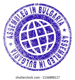 ASSEMBLED IN BULGARIA stamp watermark with grunge texture. Blue vector rubber print of ASSEMBLED IN BULGARIA label with dust texture. Seal has words placed by circle and globe symbol.
