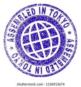 ASSEMBLED IN TOKYO stamp watermark with grunge texture. Blue vector rubber print of ASSEMBLED IN TOKYO tag with grunge texture. Seal has words arranged by circle and planet symbol.