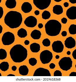 Assorted black ink circles isolated on orange background. Cute spotted monochrome seamless pattern. Vector simple flat graphic hand drawn illustration. Texture.