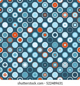 Assorted dots and circles in shades of blue with a splash of orange.
