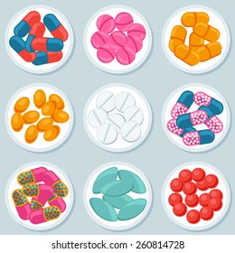 Assortment of pills and capsules in container.