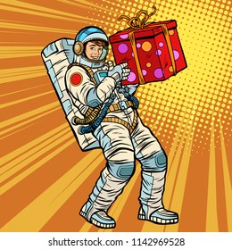 Astronaut birthday with a gift. Pop art retro vector illustration kitsch vintage drawing