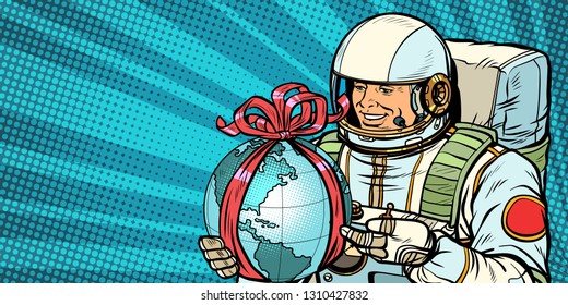 Astronaut gives the planet Earth. Pop art retro vector illustration drawing kitsch vintage