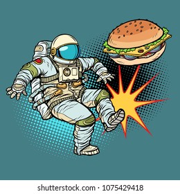 Astronaut kicks Burger fast food, proper nutrition. Pop art retro vector illustration cartoon comics kitsch drawing