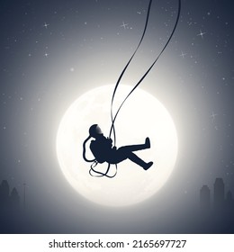 Astronaut on swing. Cosmonaut silhouette. Night city in fog. Full Moon